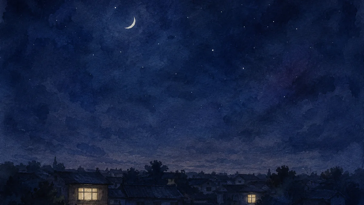 夜の街の遠景に離れてともる二つの窓あかり