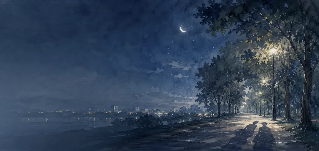 夜の並木道に落ちた二つの長い影